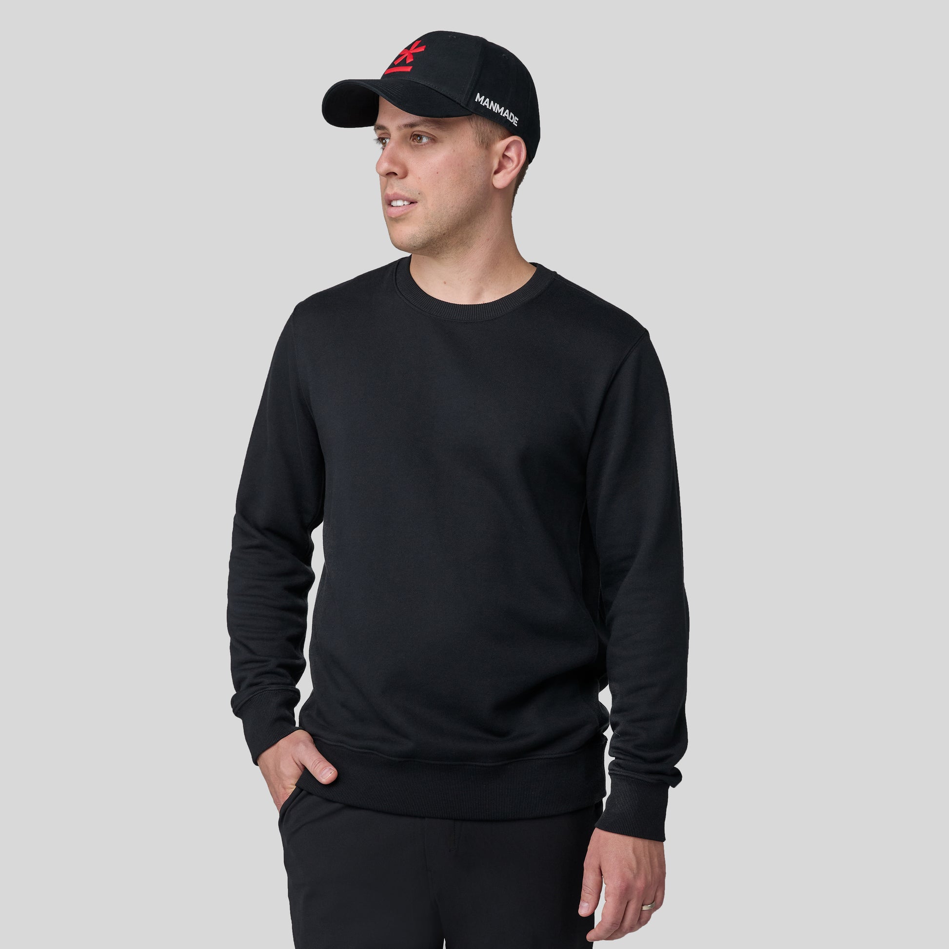 Berto wearing the black sweatshirt on a gray background