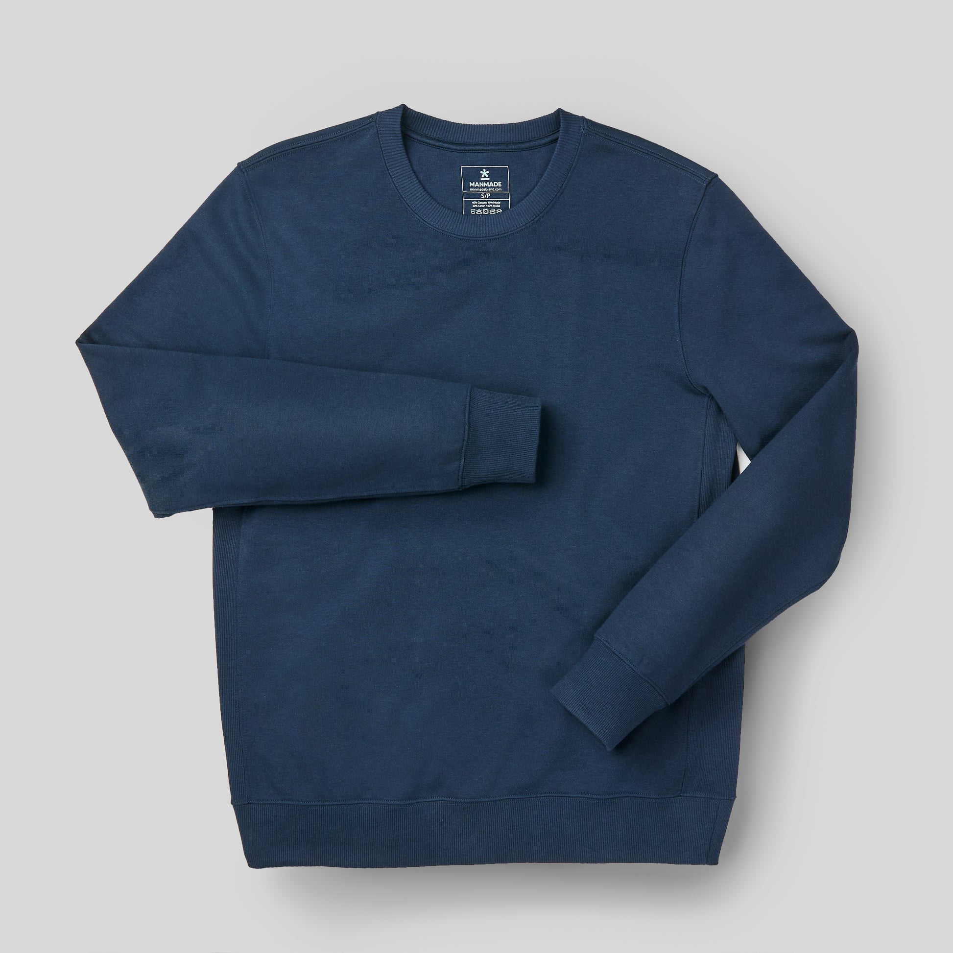 The Manmade blue sweatshirt on a light gray background