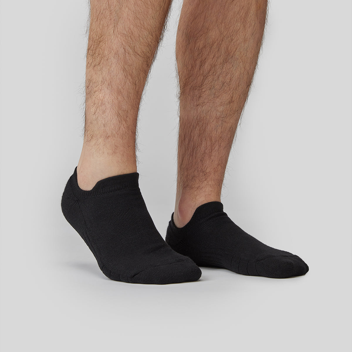 Model standing with the manmade black low cut socks